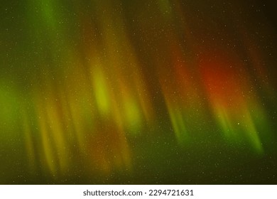 Night polar starry sky and Northern lights. Red green aurora borealis