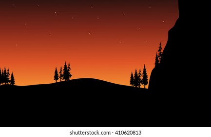 At night silhouette of tree in hills