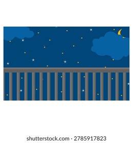 Night sky with moon and stars over fence