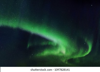 Night starry sky and Northern lights. Green aurora borealis