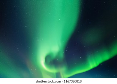 Night starry sky and Northern lights. Green aurora borealis