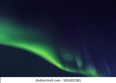 Night starry sky and Northern lights. Green aurora borealis