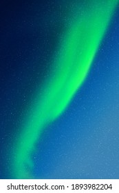 Night starry sky and Northern lights. Green aurora borealis