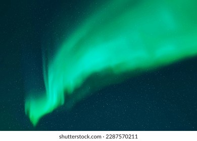 Night starry sky and Northern lights. Bright green aurora borealis