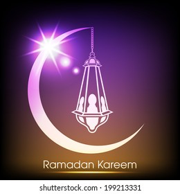 night view of a arabic lamp hanging through a illuminated colourful moon for the celebration of ramadan kareem and eid mubarak and other muslim festivals.
