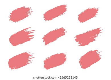 Nine abstract, coral-toned paint brush strokes on a white background.