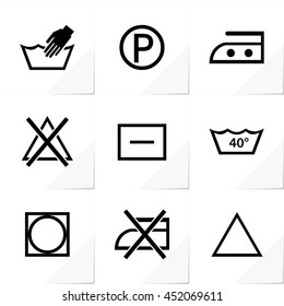 Nine Assorted Washing Symbols Hand and Machine Wash Bleaching Ironing Drying Cleaning Icons - Black Elements on White Natural Paper Effect Background - Pictogram Sign Stencil Style