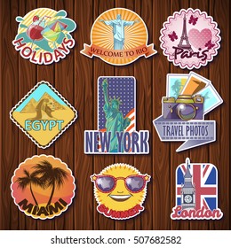 Nine isolated travel sticker designs with city sights statues towers symbols on a wooden table background vector illustration