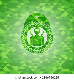 ninja icon inside green emblem with mosaic background