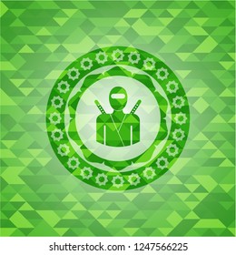ninja icon inside green emblem. Mosaic background