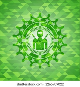 ninja icon inside green emblem. Mosaic background