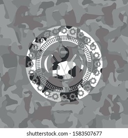 ninja icon inside grey camouflaged emblem