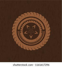 ninja star icon inside badge with wooden background