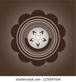 ninja star icon inside badge with wooden background