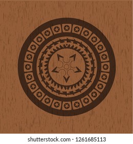 ninja star icon inside badge with wooden background