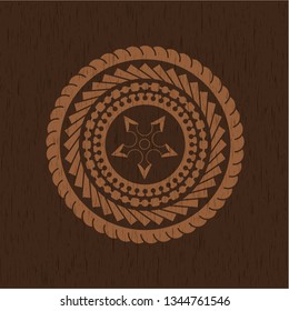 ninja star icon inside badge with wood background