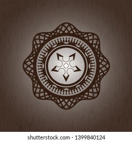 ninja star icon inside badge with wood background