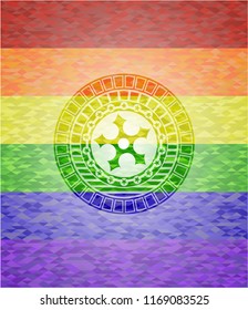 ninja star icon inside emblem on mosaic background with the colors of the LGBT flag