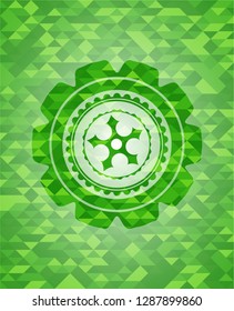 ninja star icon inside green emblem. Mosaic background