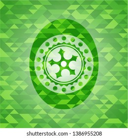 ninja star icon inside green emblem with triangle mosaic background