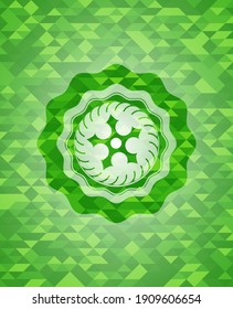 ninja star icon inside green emblem with mosaic background. 