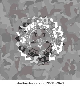 ninja star icon inside grey camouflage emblem