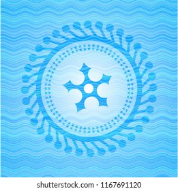 ninja star icon inside light blue water wave style emblem.