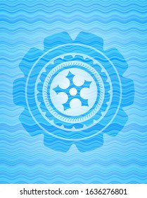 ninja star icon inside light blue water emblem background.