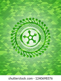ninja star icon inside realistic green mosaic emblem