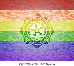 icono de la estrella ninja sobre fondo de mosaico con los colores de la bandera LGBT. 