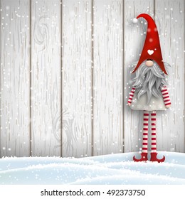 Nisser in Norway and Denmark, Tomtar in Sweden or Tonttu in Finnish, Scandinavian folklore elves, nordic christmas motive, Tomte standing in front of gray wooden wall in snow, vector illustration, eps