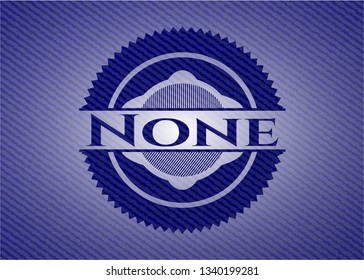 None badge with denim background