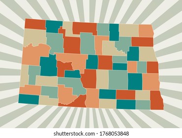 North Dakota map. Poster with map of the US state in retro color palette. Shape of North Dakota with sunburst rays background. Vector illustration.