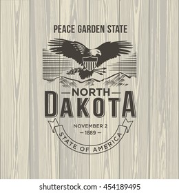 North Dakota Peace Garden State, stylized emblem of the state of America, eagle, on wooden background