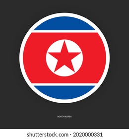 North Korea circle flag icon with white border on dark grey background. North Korea button flag icon on barely dark background.