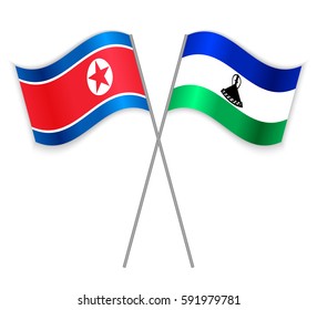 North Korean and Basotho crossed flags. North Korea combined with Lesotho isolated on white. Language learning, international business or travel concept.