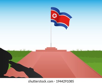 The North Korean Flag Flies Above The Pole In The Shadow Of A Soldier Saluting The Flag