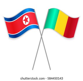 North Korean and Guinean crossed flags. North Korea combined with Guinea isolated on white. Language learning, international business or travel concept.