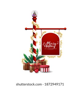 North Pole candy cane arrow sign decorated with garland and presents isolated on white background. Christmas template of red road and transportation sign with copy space for your art