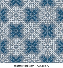 Norwegian knitted pattern with snowflakes in vintage blue color. Woolen seamless knitted pattern