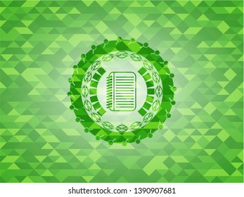 note book icon inside green emblem with mosaic background