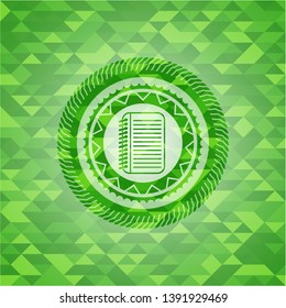 note book icon inside green emblem with triangle mosaic background