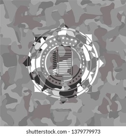 note book icon inside grey camouflage emblem