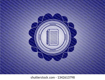 note book icon inside jean or denim emblem or badge background