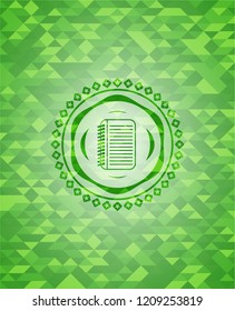 note book icon inside realistic green emblem. Mosaic background