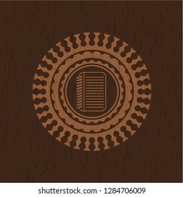note book icon inside retro wood emblem