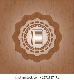 note book icon inside vintage wooden emblem