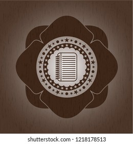 note book icon inside wooden emblem