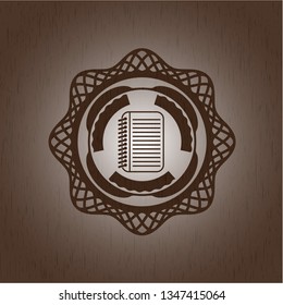 note book icon inside wooden emblem. Vintage.