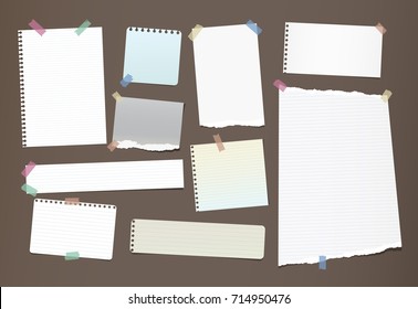 Note, notebook, copybook paper strips, sheets stuck with colorful sticky tape on brown background.